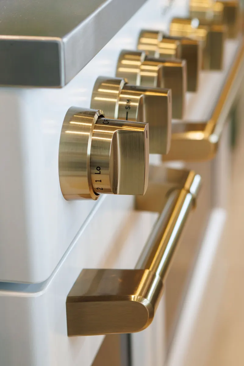 Close up of brass knobs on a range