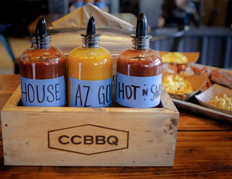 Barbecue sauce bottles in a branded wooden crate