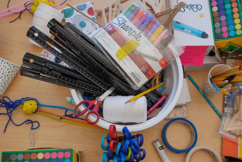 Overhead view of colorful craft and coding supplies spread on a table