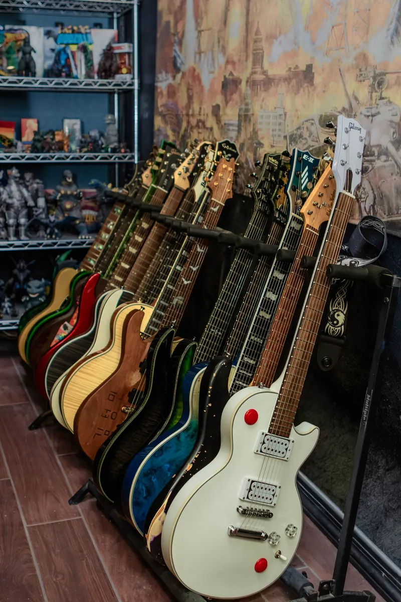 A row of electric guitars on stands in a recording studio