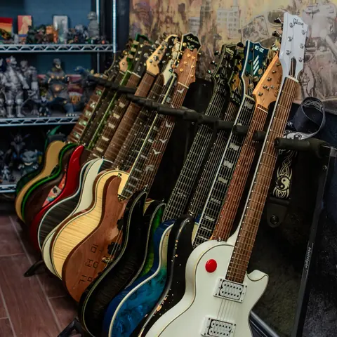 A row of guitars on stands in a recording studio