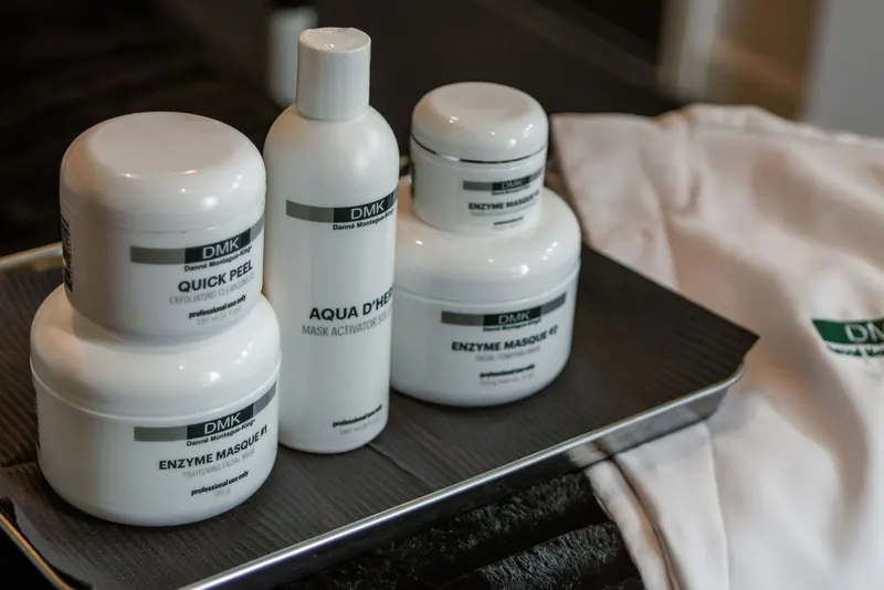 Skincare products arranged on a black tray