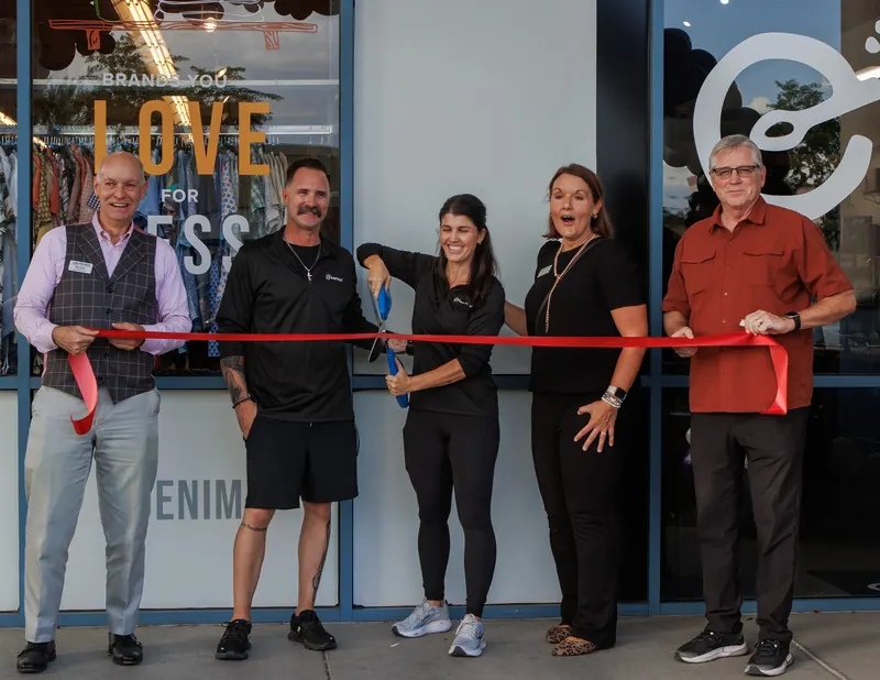 Owners, chamber members and the Everbowl crew line up behind a red ribbon inside the new shop